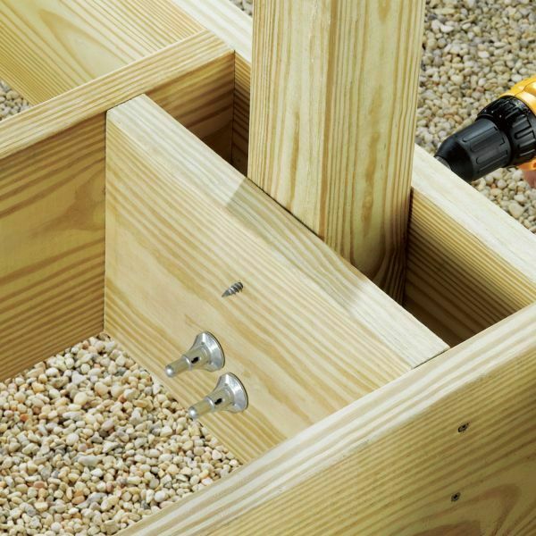 This image depicts a FastenMaster ThruLOK system being drilled into wooden boards.